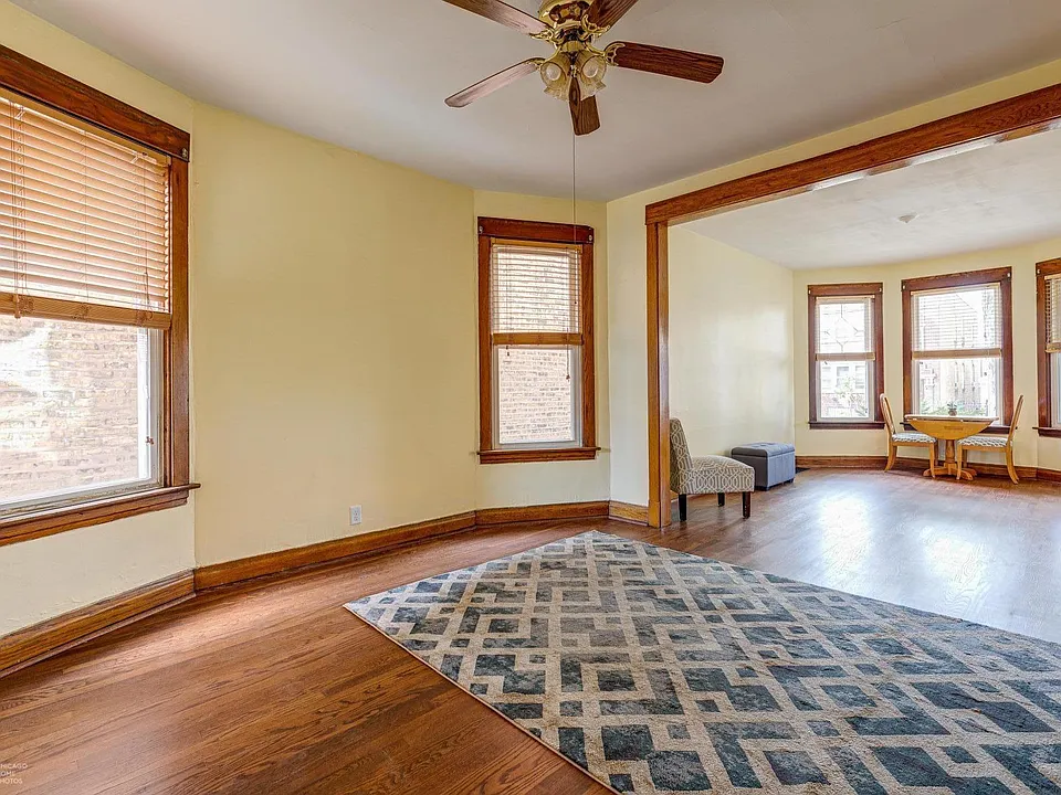 Large living room and dining room with refinished hardwood floors and fresh paint