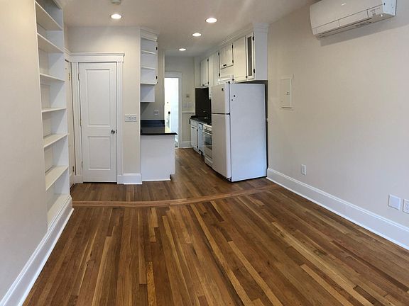 View from living room into kitchen. My amateur photography makes it look like the floors are uneven. They are not uneven.