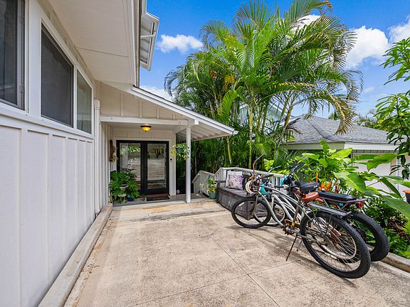 Welcoming covered entryway with etched glass double doors. Property has parking for 3-4 vehicles and plenty of storage for bikes and beach toys.