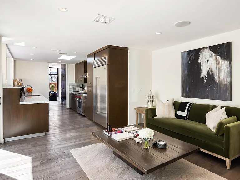 Relax in the additional seating area, complete with a TV and desk, offering the perfect spot to unwind or catch up on work.