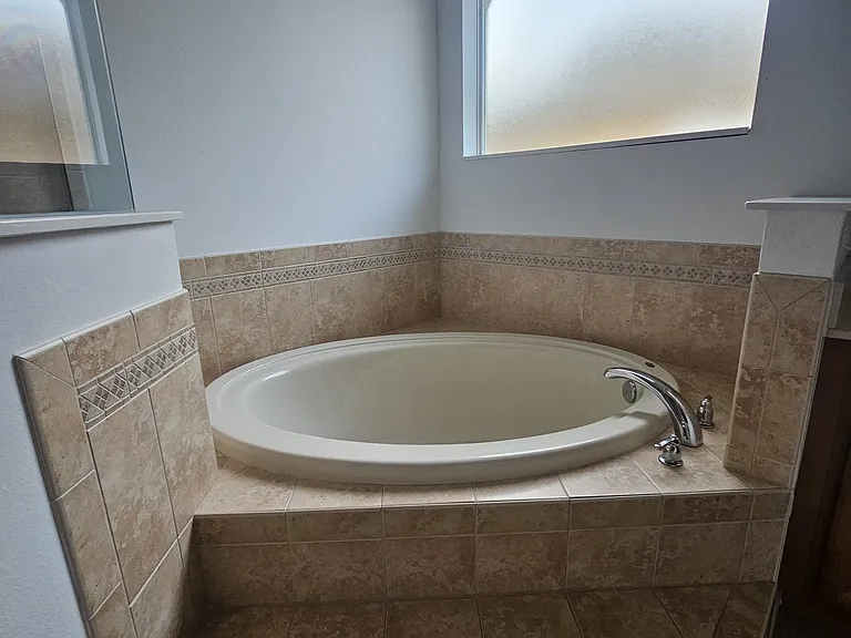 Large tub with great natural sunlight in master suite bathroom. (2nd bathtub in the house)