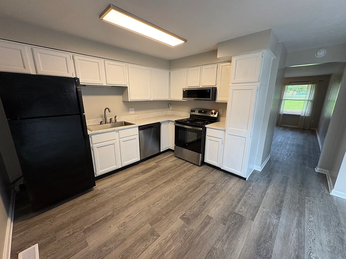 Open concept kitchen with newer countertop, sink and faucet. Refridgerator has ice maker. Numerous kitchen cabients and pantry cabinet. - 7788 Clyo Rd #7788