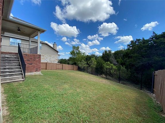 Oversized yard with covered patio + backs to a greenbelt space!