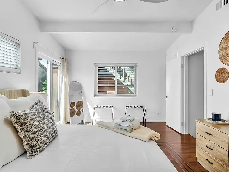 The bedroom 2 features a queen bed and direct access to the balcony