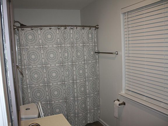 The fully furnished bathroom with new shower and tub as well as a half bath in the hallway in the condo.