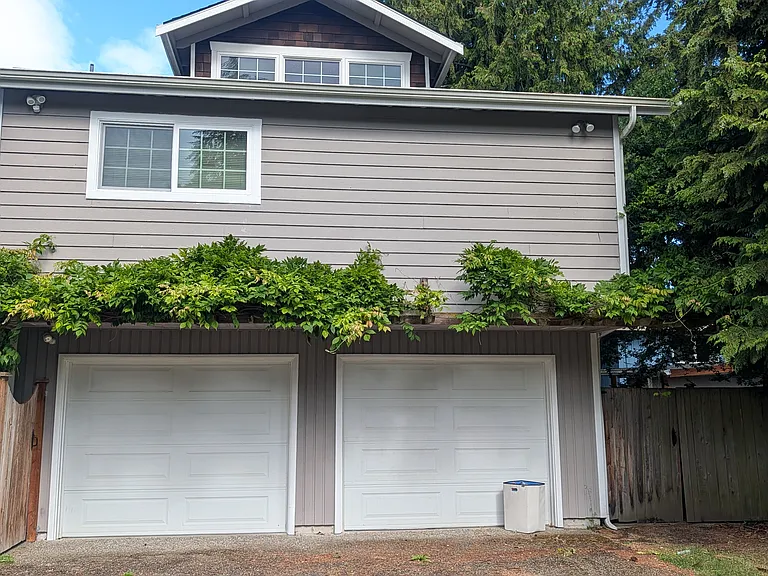 Front of apartment above garages, tenant can tandem park 2 cars in front of left garage and offstreet parking in the yard to the left