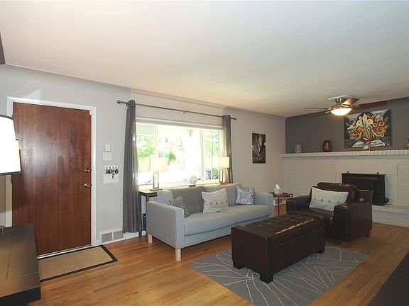Large main floor living room with automatic sun sensing blind and a grand wood burning fireplace.