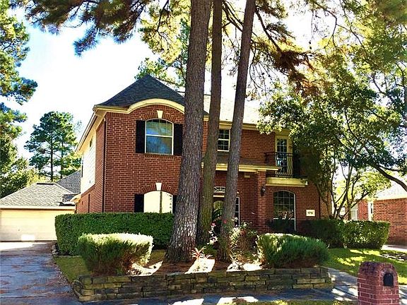 Front view showing detached garage with long driveway.