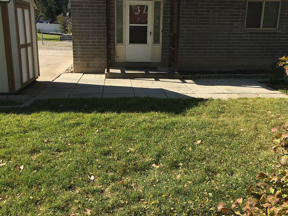 Looking West, entry, patio and storage shed
