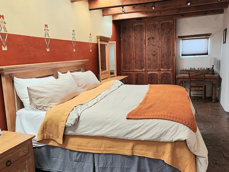 Master bedroom includes a workspace and small seating area by kiva. Walk in closet as well as large built in closet space.