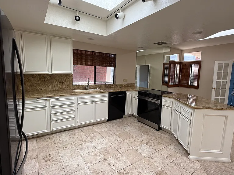 Large kitchen with ample storage; bright with multiple sky lites