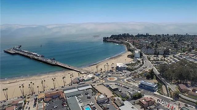 Walk past the Boardwalk to the Wharf and Cowell Beach Surfing