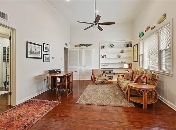 This view shows the other portion of the large living area 30+ ft long! You can make this a formal dining area or move your living area to this portion. Beautiful shelving and a large bonus storage area pictured on this back wall.