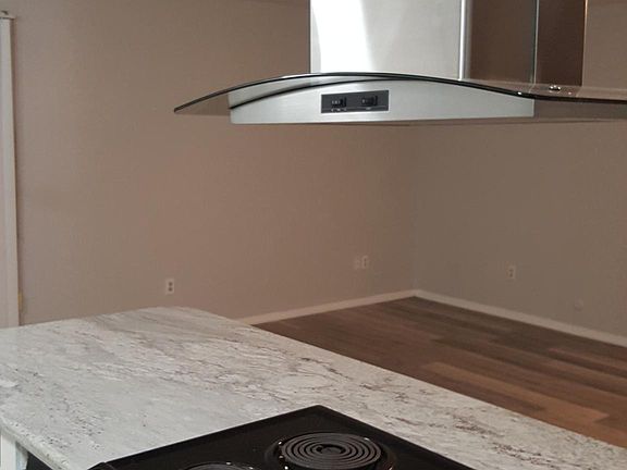 Island kitchen with vent a hood.