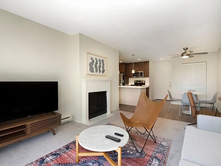 Furnished+ apartment homes come outfitted with a sofa, side chair, coffee table, TV stand and 50" Television (Representative Image exact items and style of furnishings may vary)