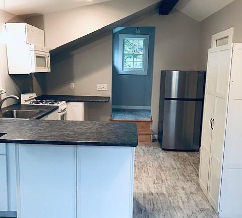 View of kitchen and entry from living area