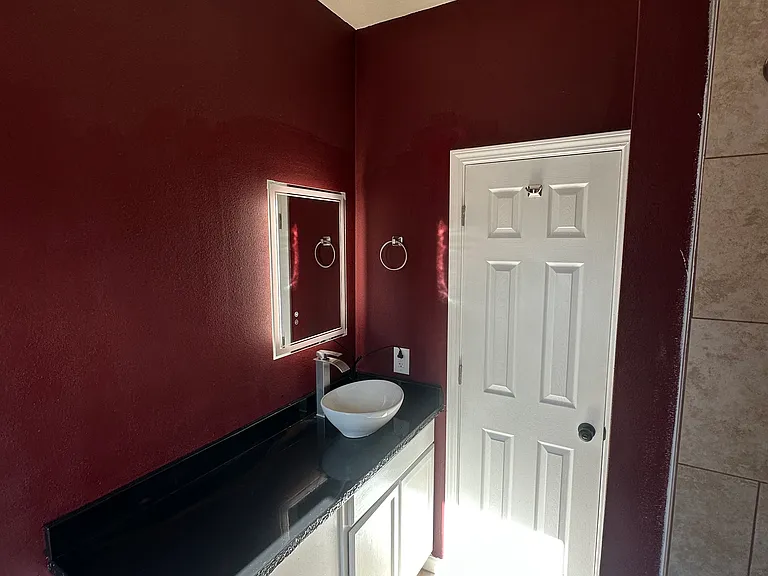 Bathroom has light up mirror lots of counter space and drawers and under sink space.