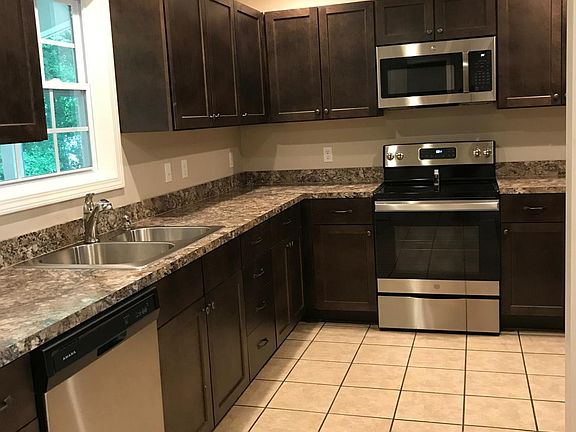Recent renovations to the house include new kitchen appliances (side-by-side fridge, oven with over-the-range microwave, dishwasher, disposal) counters, tile floors and custom cabinetry