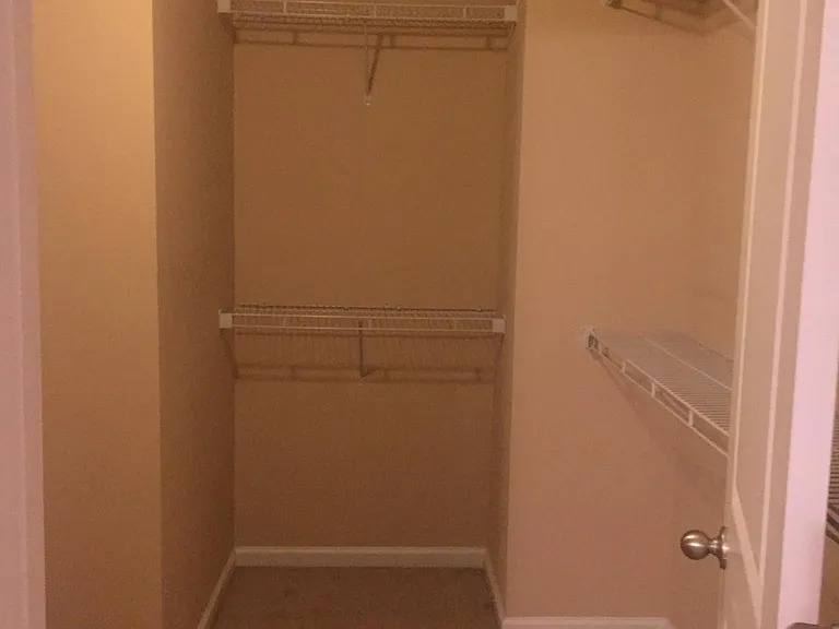 Primary bedroom walk-in closet