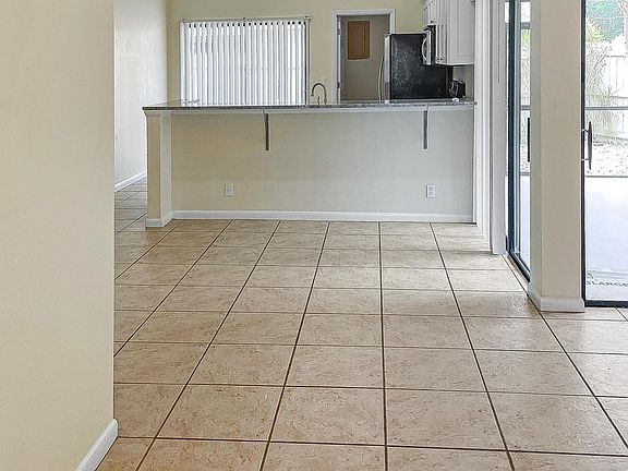 Front door entrance to open floor plan Living room, dining area and kitchen