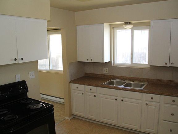 Kitchen with new counter tops and refinished cabinets