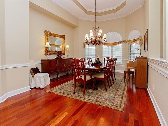 Formal dining room with tray ceilings and crown molding