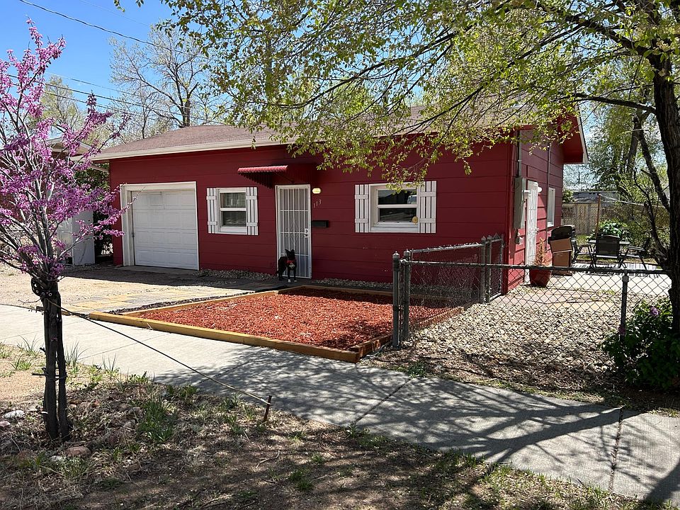 Front of house with one car garage, private patio and fenced yard.