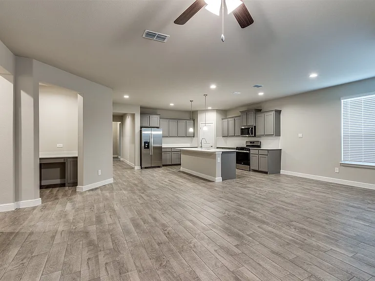 Kitchen featuring a center island with sink, light wood-type flooring, sink, and appliances with stainless steel finishes
