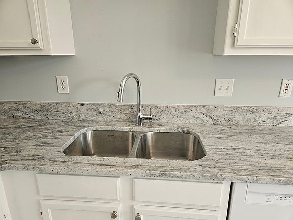 River white granite with a double extra deep stainless steel sink.