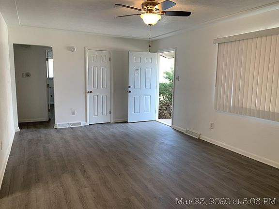 Living room to front door, closet, & bedroom hallway from Kitchen view