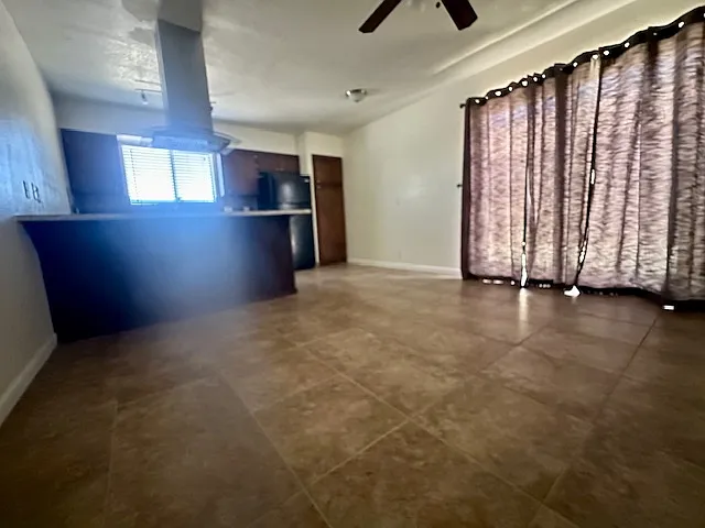 Kitchen/living room with sliding glass door allows for great natural lighting.