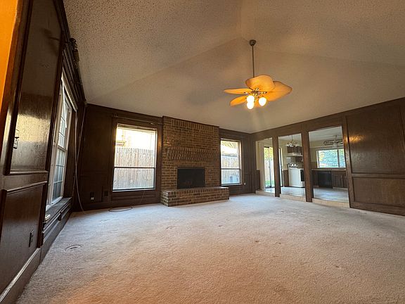 Large living room with vaulted ceiling and fireplace
