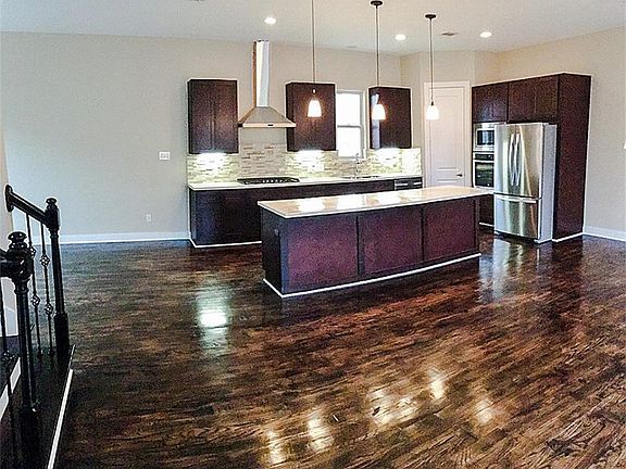 Stainless steel appliances,  Kitchen island with  tons of storage!   Great space for entertainment.( shoe molding is matches cabinets.)