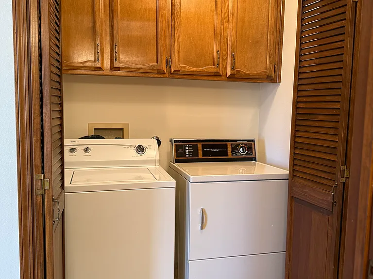 Laundry room with exhaust fan and storage