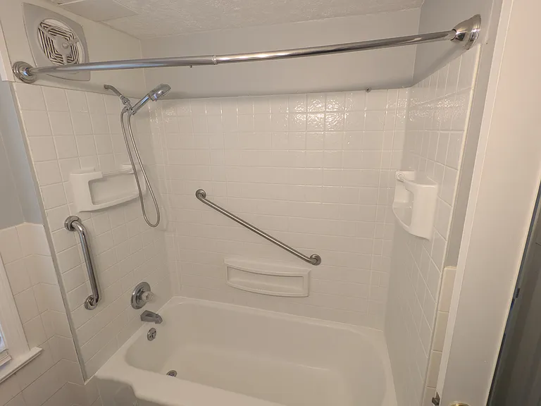 Safety handles in tub area. Brand new showerhead.