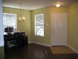 Formal dining room off of entry with laminated wood floors