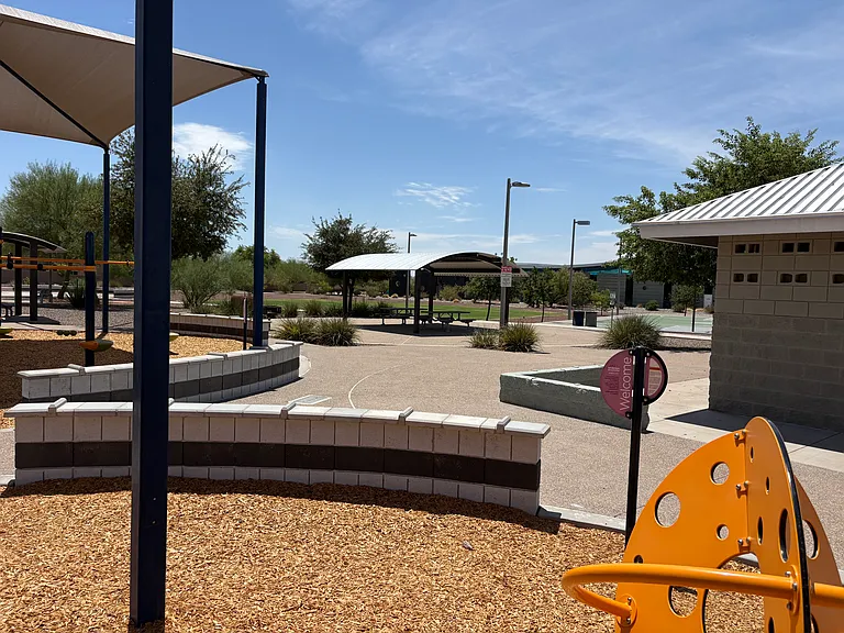 Park with children playground with bathrooms and view of library.