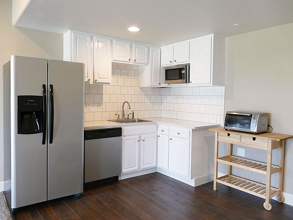 Kitchen with open concept to living room. Kitchen includes Brand new refrigerator, dishwasher, garbage disposal. Also includes microwave, countertop taster oven, and 2 burner hot plate.