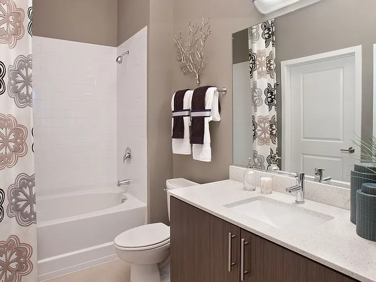 Bathroom with white quartz countertop, espresso cabinetry and hard surface flooring
