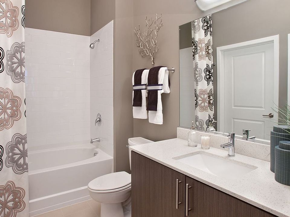 Bathroom with white quartz countertop, espresso cabinetry and hard surface flooring