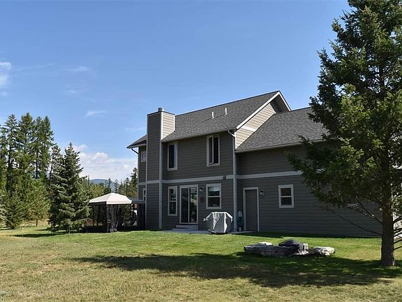 The backyard comes with a fire pit and spacious lawn. No ne