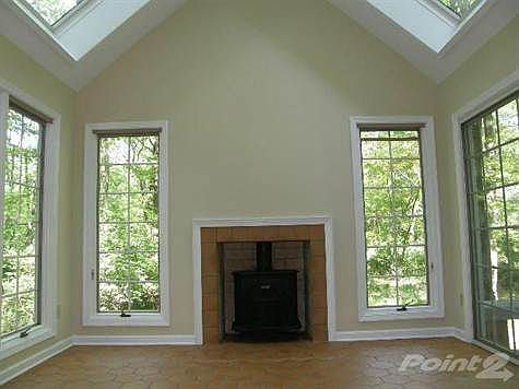 Sunroom with fireplace & vaulted ceiling w/skylights