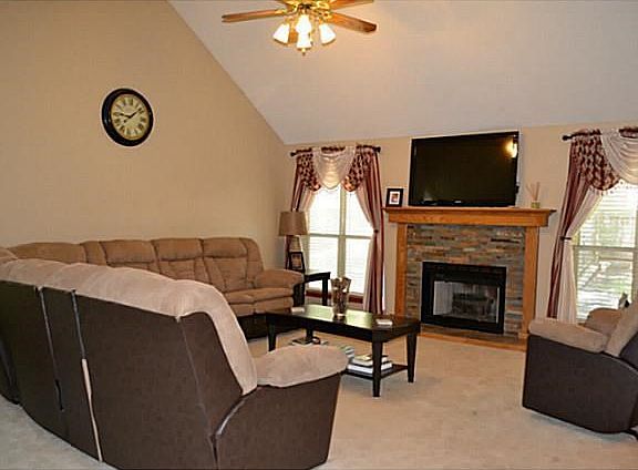 Living Room. Newly re-faced fireplace, fresh paint, and vaulted ceiling.