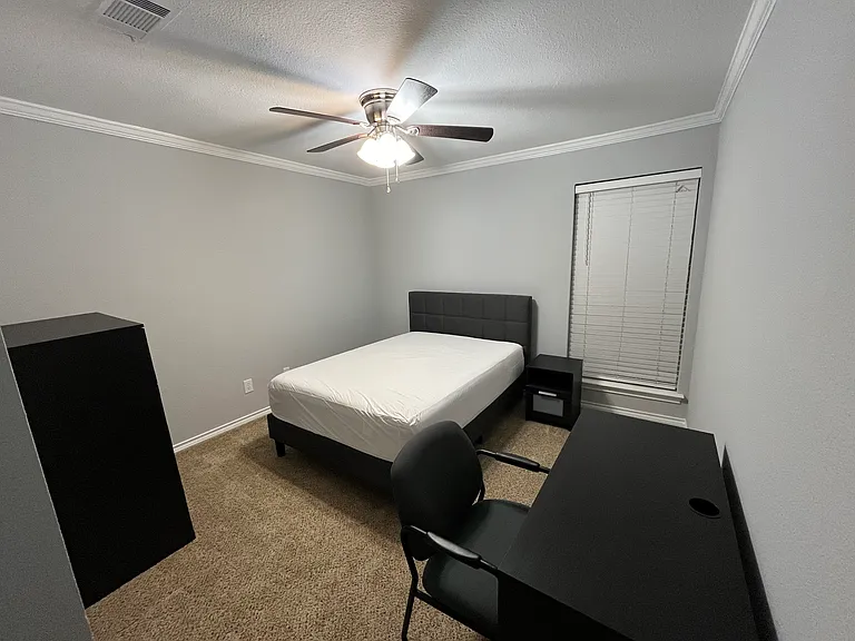 Secondary Bedroom #1, furnished with full size bed, tall dresser, desk, chair, & nightstand. Walk in closet. Private space for occupant of secondary bedroom #1.