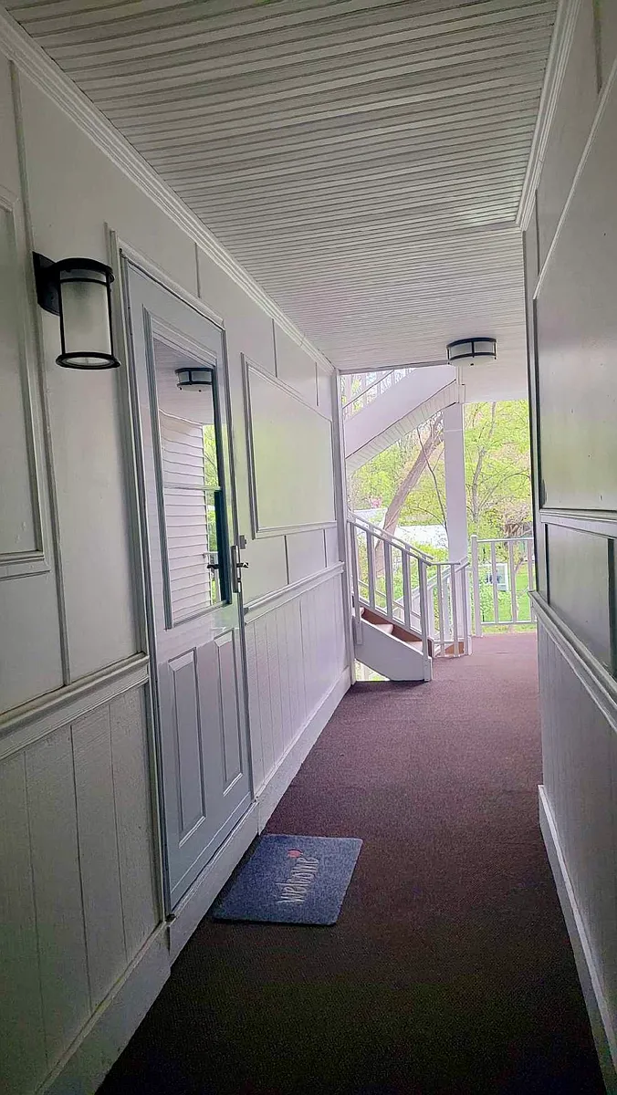 Welcoming covered walkway entrance adding charm and convenience to everyday condo living. - 141 Raintree Ln