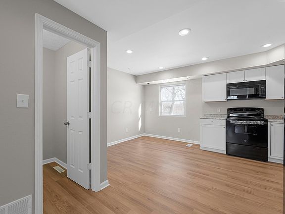 view of kitchen, dining room, and half bath