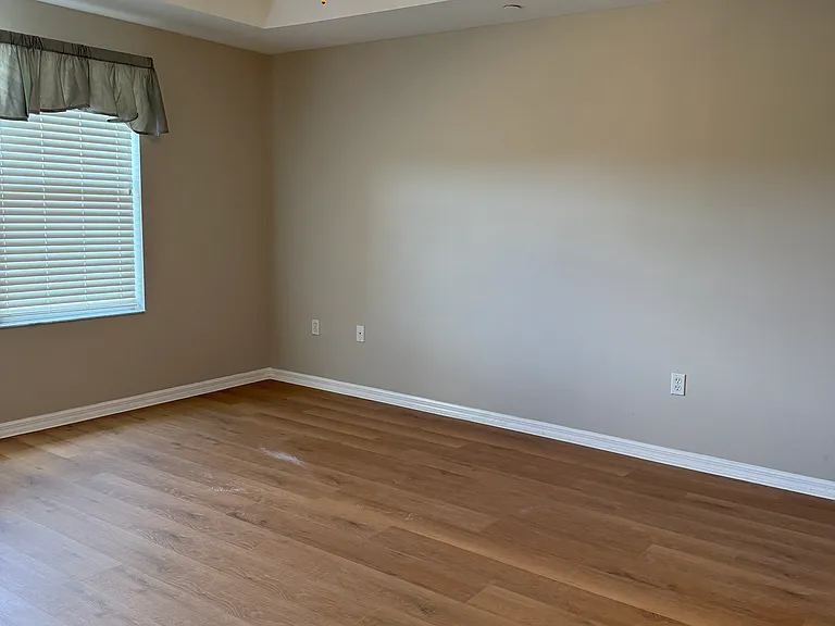 Primary bedroom freshly painted with new floors