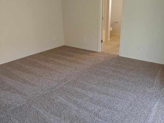 Master bedroom, carpeted, with master bath, 2 sinks and large walk-in closet