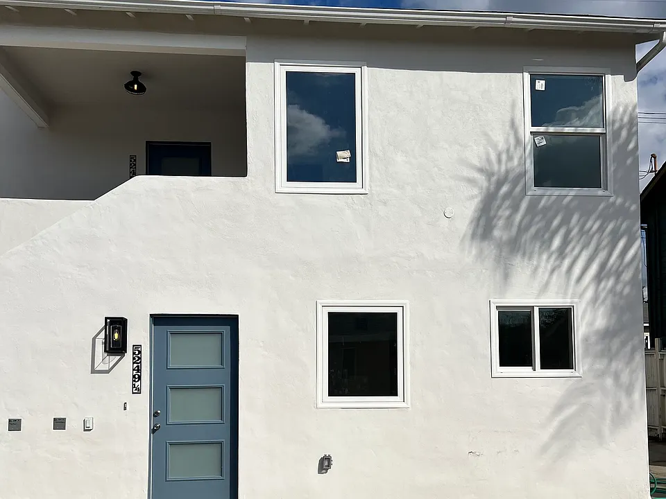 Exterior view of the 2 unit newly remodeled building in the rear. This unit is the entire top floor unit.