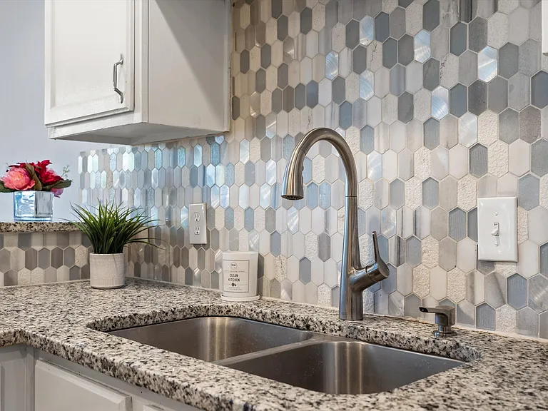 If you need to wash dishes, it might as well be in an updated sink with a gooseneck faucet and pretty tile!
